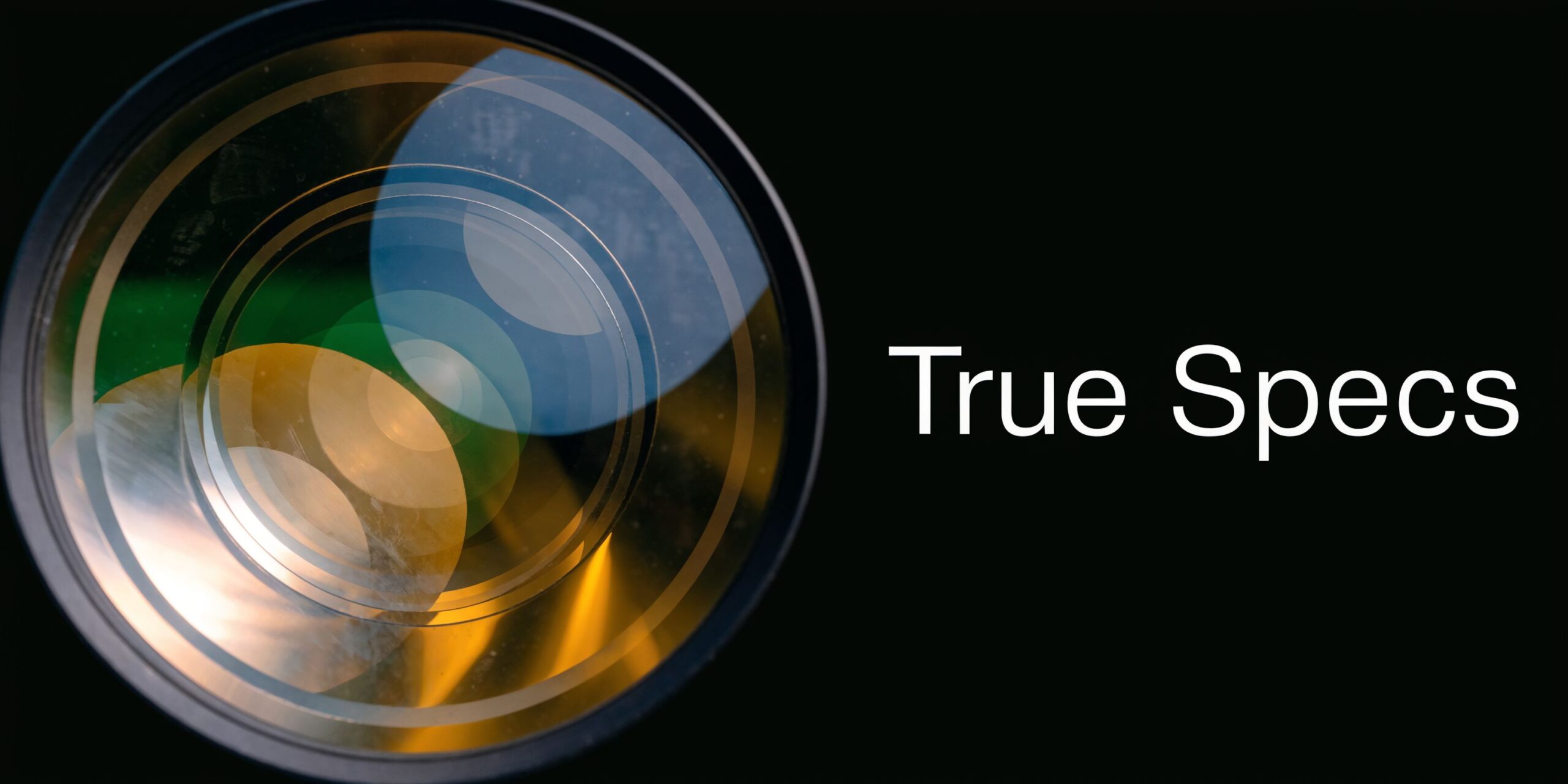 A close-up view of a high-end camera lens featuring vibrant circular light flares and reflections.