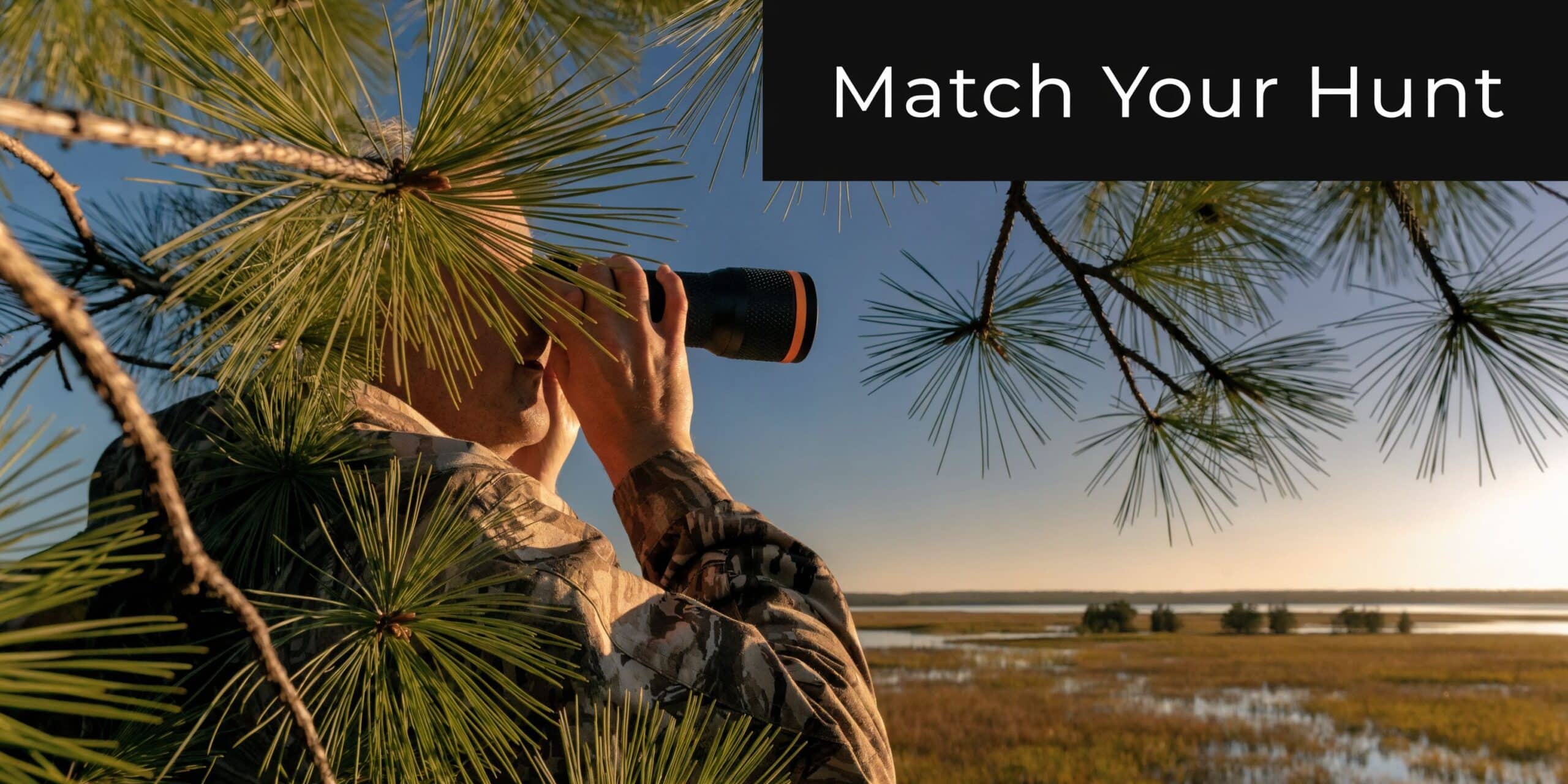 A hunter in camouflage gear looks through a thermal imager while observing a marshy landscape at sunset.